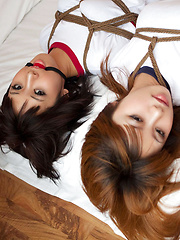 Dimdim Asian and nasty babe in t-shirts are tied in ropes on bed